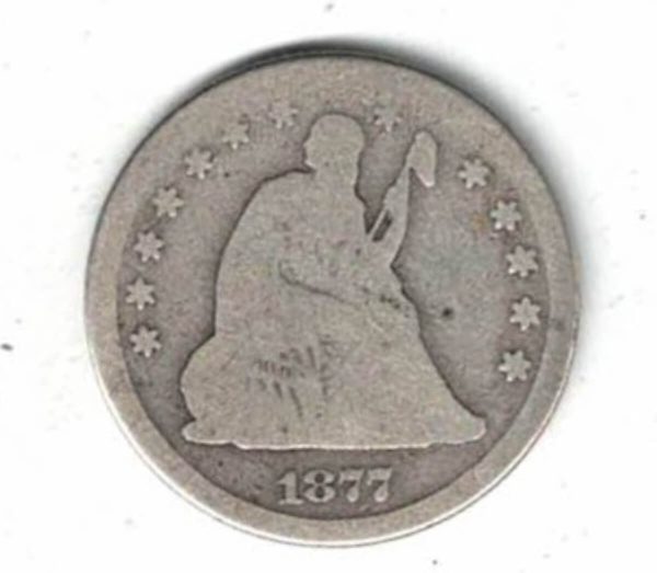 1877 CC USA Silver Quarter Dollar Coin. The Obverse features a seated liberty looking right above her shoulder. The reverse features an eagle with arrows.