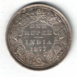 1877 India Silver One Rupee Coin. The obverse side of this coin features the crowned portrait of Queen Victoria facing left.