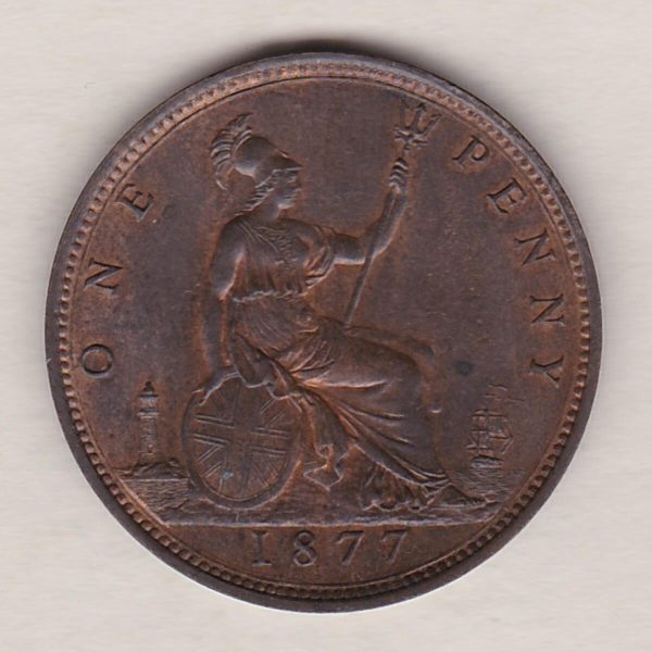 1877 bronze penny coin featuring the young head portrait of Queen Victoria on the Obverse. The coin depicts Britannia seated to the right on the Reverse.