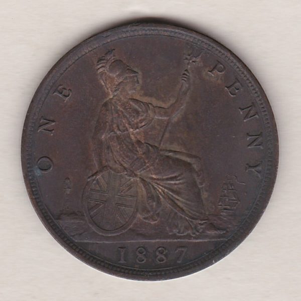 1887 bronze penny coin featuring the young head portrait of Queen Victoria on the Obverse. The coin depicts Britannia seated to the right on the Reverse.