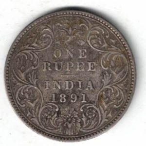 1891 India Silver One Rupee Coin. The obverse side of this coin features the crowned portrait of Queen Victoria facing left.