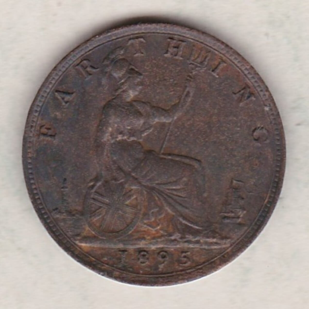 1895 bronze farthing coin featuring the young head Queen Victoria on the Obverse. Britannia seated facing right on the Reverse.