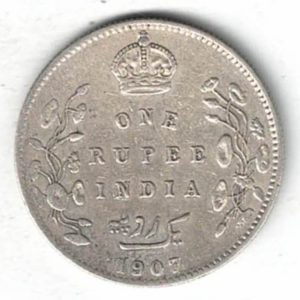 1907 India Silver One Rupee Coin. The obverse features Edward VII The reverse has the denomination and date with lotus flowers.