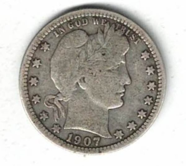 1907 USA Barber Silver Quarter Dollar Coin. The Obverse features the bust of miss liberty looking right. The reverse features an heraldic eagle.