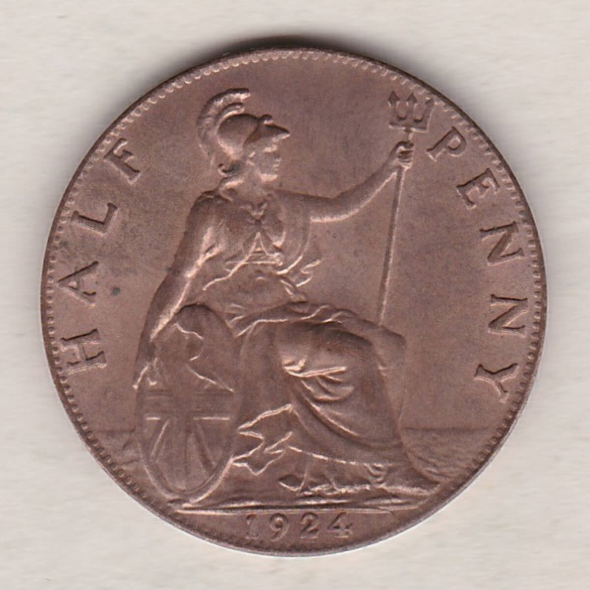 1924 Bronze Halfpenny coin featuring the portrait of King George V on the obverse. The reverse side of the coin depicts Britannia seated to the right.