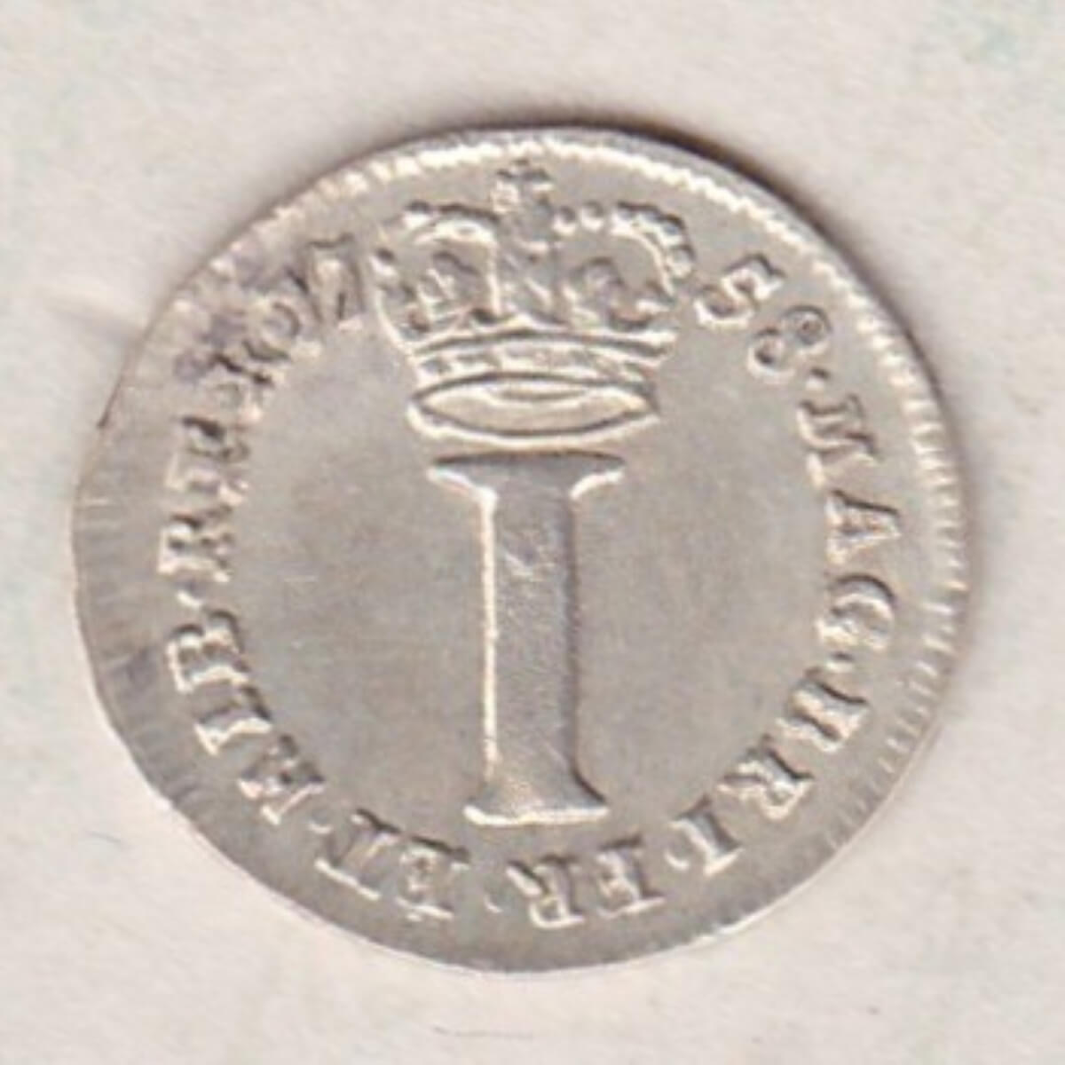 1758 Silver Maundy Penny coin featuring King George II on the obverse. A large central denomination below a crown dividing the date on the reverse.