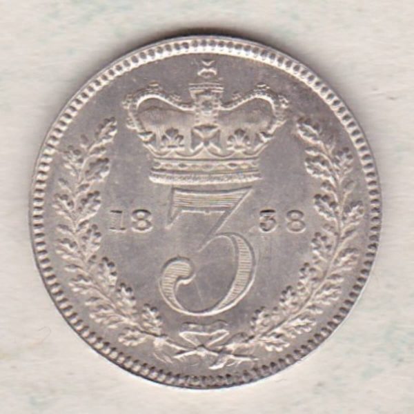 1838 Silver Maundy Threepence coin featuring Queen Victoria on the obverse. The reverse features a crowned denomination dividing date within an oak wreath. 
