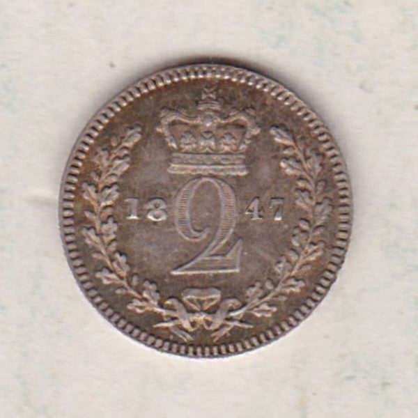 1847 Silver Maundy Twopence coin featuring Queen Victoria on the obverse. A crowned denomination dividing the date on the reverse.