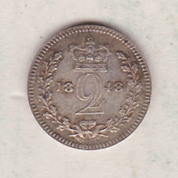 1848 Silver Maundy Twopence coin featuring Queen Victoria on the obverse. A crowned denomination dividing the date on the reverse.
