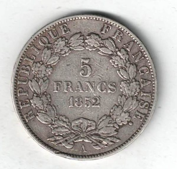 1852 A France Silver Five Francs Coin. The obverse features Louis-Napoleon Bonaparte facing left. The reverse features the value within wreath.