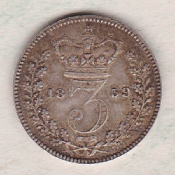 1859 Silver Maundy Threepence coin featuring Queen Victoria on the obverse. The reverse features a crowned denomination dividing date within an oak wreath. 