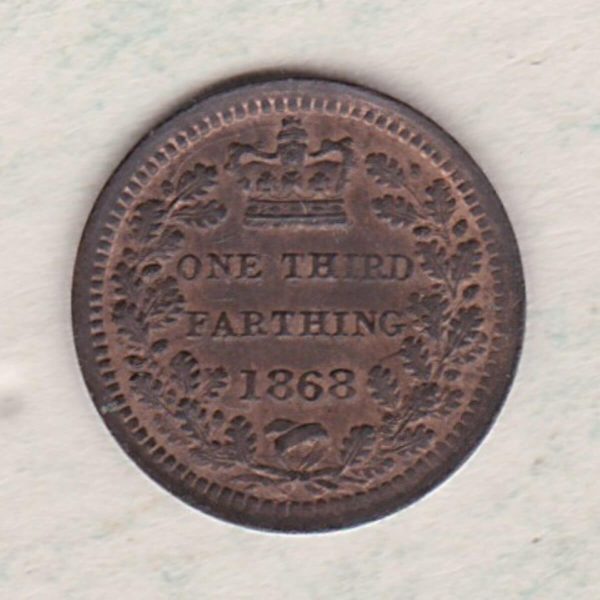 1868 Bronze Third Farthing the portrait of Queen Victoria on the obverse. The reverse shows the crowned value and date within an laurel wreath.