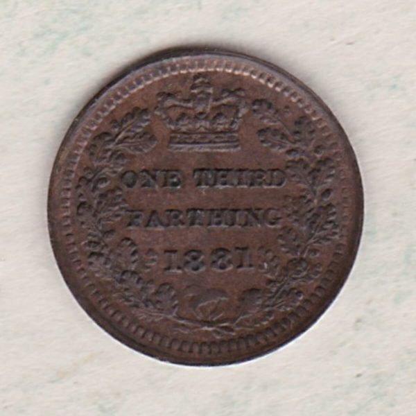 1881 Bronze Third Farthing the portrait of Queen Victoria on the obverse. The reverse shows the crowned value and date within an laurel wreath.