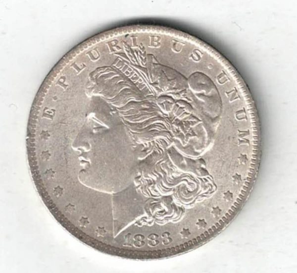 1883 O Silver USA Morgan Dollar coin featuring lady liberty on the obverse. The eagle holding arrows and an olive branch on the reverse.
