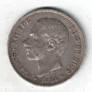 1884 MSM Spain Silver Five Pesetas Coin. The obverse features the bust of Alfonso XII left. The reverse features the crowned coat arms of Spain.