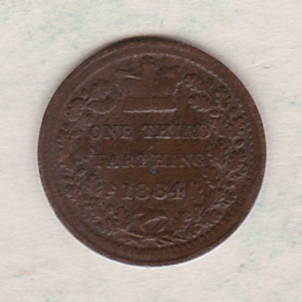 1884 Bronze Third Farthing the portrait of Queen Victoria on the obverse. The reverse shows the crowned value and date within an laurel wreath.