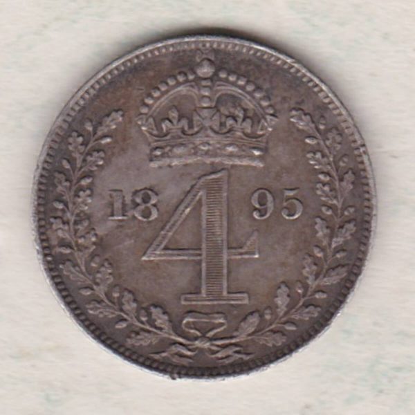 1895 silver maundy fourpence coin featuring Queen Victoria on the Obverse. The crowned denomination dividing date within an oak wreath on the Reverse.