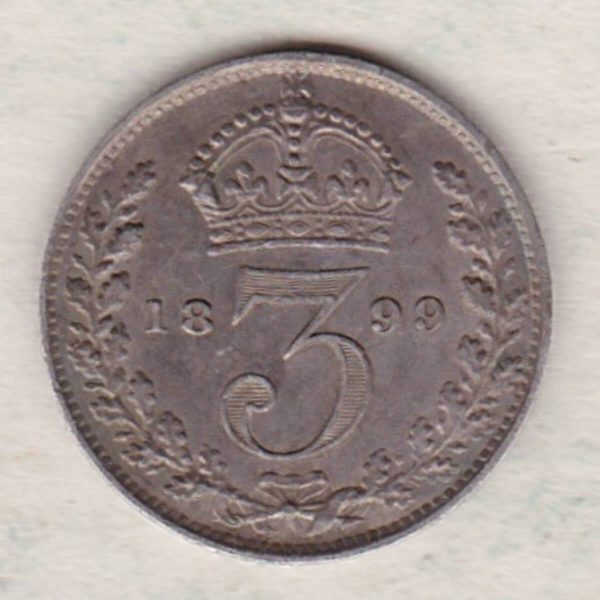 1899 Silver Maundy Threepence coin featuring Queen Victoria on the obverse. The reverse features a crowned denomination dividing date within an oak wreath. 