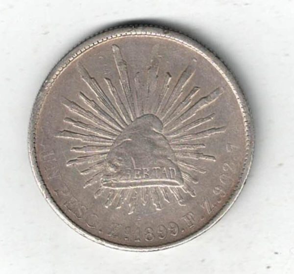 1899 Zs FZ Mexico Silver One Peso Coin. The obverse features the national arms of mexico with eagle & snake. All coins are in stock.