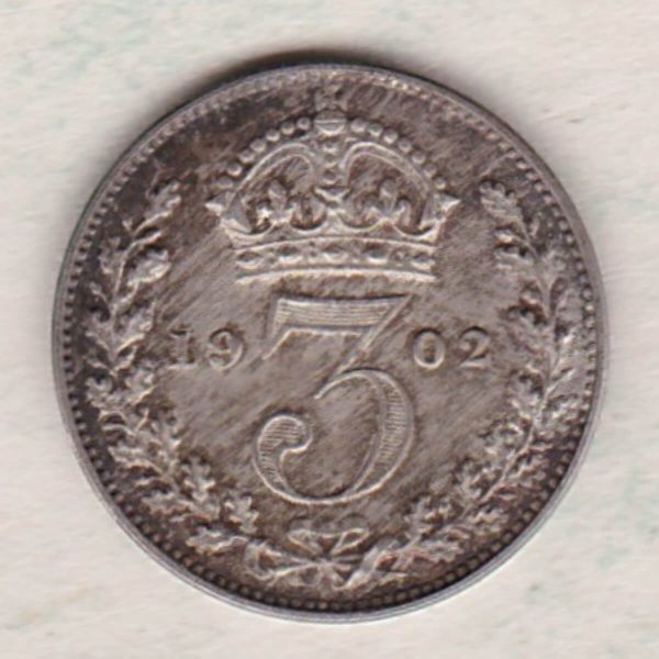 1902 Silver Maundy Threepence coin featuring King Edward VII on the obverse. The reverse features a crowned denomination dividing date within an oak wreath. 