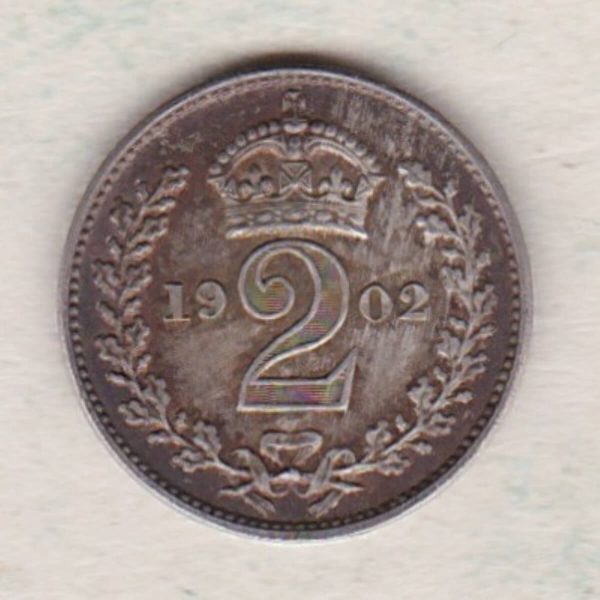 1902 Silver Maundy Twopence coin featuring King Edward VII on the obverse. A crowned denomination dividing the date on the reverse.