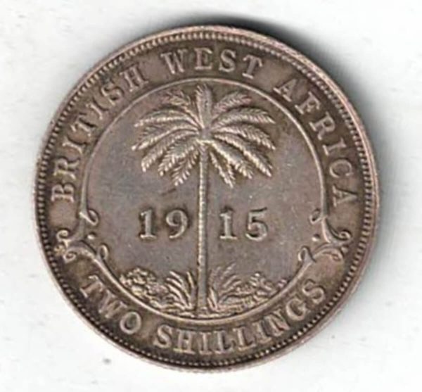 1915 H British West Africa Silver Two Shillings Coin. The obverse features the bust of king George V facing left. The reverse features a palm tree.