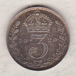 1920 Silver Maundy Threepence coin featuring King George V on the obverse. The reverse features a crowned denomination dividing date within an oak wreath. 