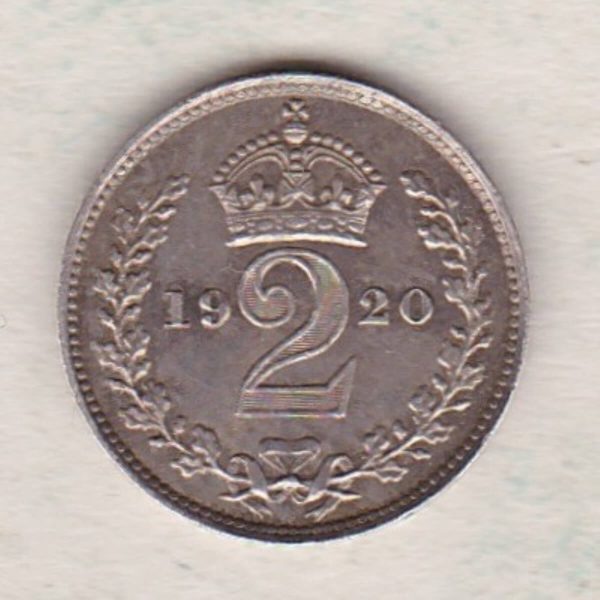 1920 Silver Maundy Twopence coin featuring King George V on the obverse. A crowned denomination dividing the date on the reverse.