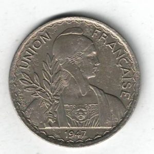 1947 French Indo China Copper-Nickel One Piastre Coin. The obverse features Marianne facing right with laurel branch with date.