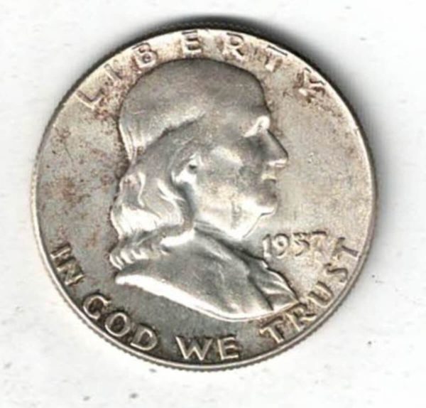 1957 USA Franklin Silver Half Dollar Coin. The obverse features Benjamin Franklin facing right. The reverse features a Liberty bell.