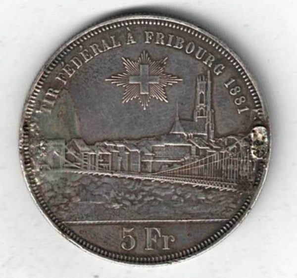Ex Mount 1881 Switzerland Silver Five Francs Coin. The obverse features arms with city views and denomination. The reverse features three figures.