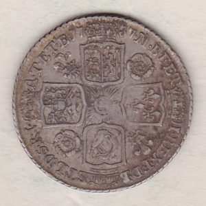 1737 silver shilling coin featuring a laureate and draped bust of George II. The crowned cruciform shields with central Garter star on the Reverse.