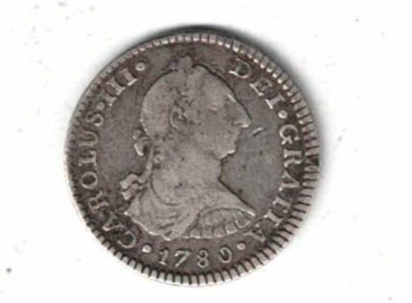 1780 FF Mexico Silver One Real Coin. The obverse features the bust facing right. The reverse features Hispanic arms a pair of pillars.