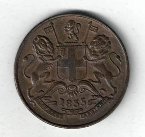 1835 India Copper Half Anna Coin. The obverse side of this coin features the coat arms of east India company. The reverse features the denomination.