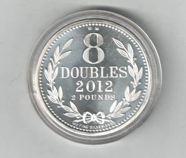 2012 Silver Guernsey One Ounce 8 Doubles. The coat of arms is on the obverse, 8 Doubles is on the reverse. The coin contains one ounce of 9999 fine silver