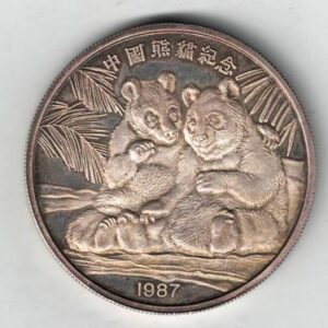Boxed 1987 China Silver Two Ounce Pandas Round. The obverse features two pandas hugging under a palm tree. The reverse features the back of the pandas.