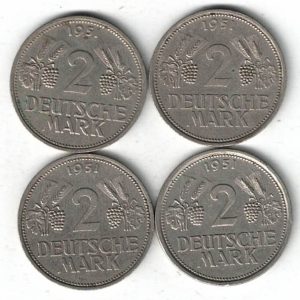Four 1951 Germany Federal Republic Two Deutsche Mark Coins. The obverse features an eagle. The reverse features the value with leaves, grapes and date.