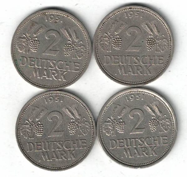Four 1951 Germany Federal Republic Two Deutsche Mark Coins. The obverse features an eagle. The reverse features the value with leaves, grapes and date.