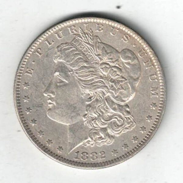 1882 O Silver USA Morgan Dollar coin featuring lady liberty on the obverse. The eagle holding arrows and an olive branch on the reverse.
