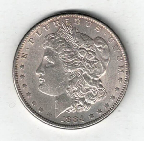 1884 Silver USA Morgan Dollar coin featuring lady liberty on the obverse. The eagle holding arrows and an olive branch on the reverse.