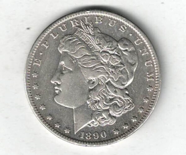 1890 O Silver USA Morgan Dollar coin featuring lady liberty on the obverse. The eagle holding arrows and an olive branch on the reverse.