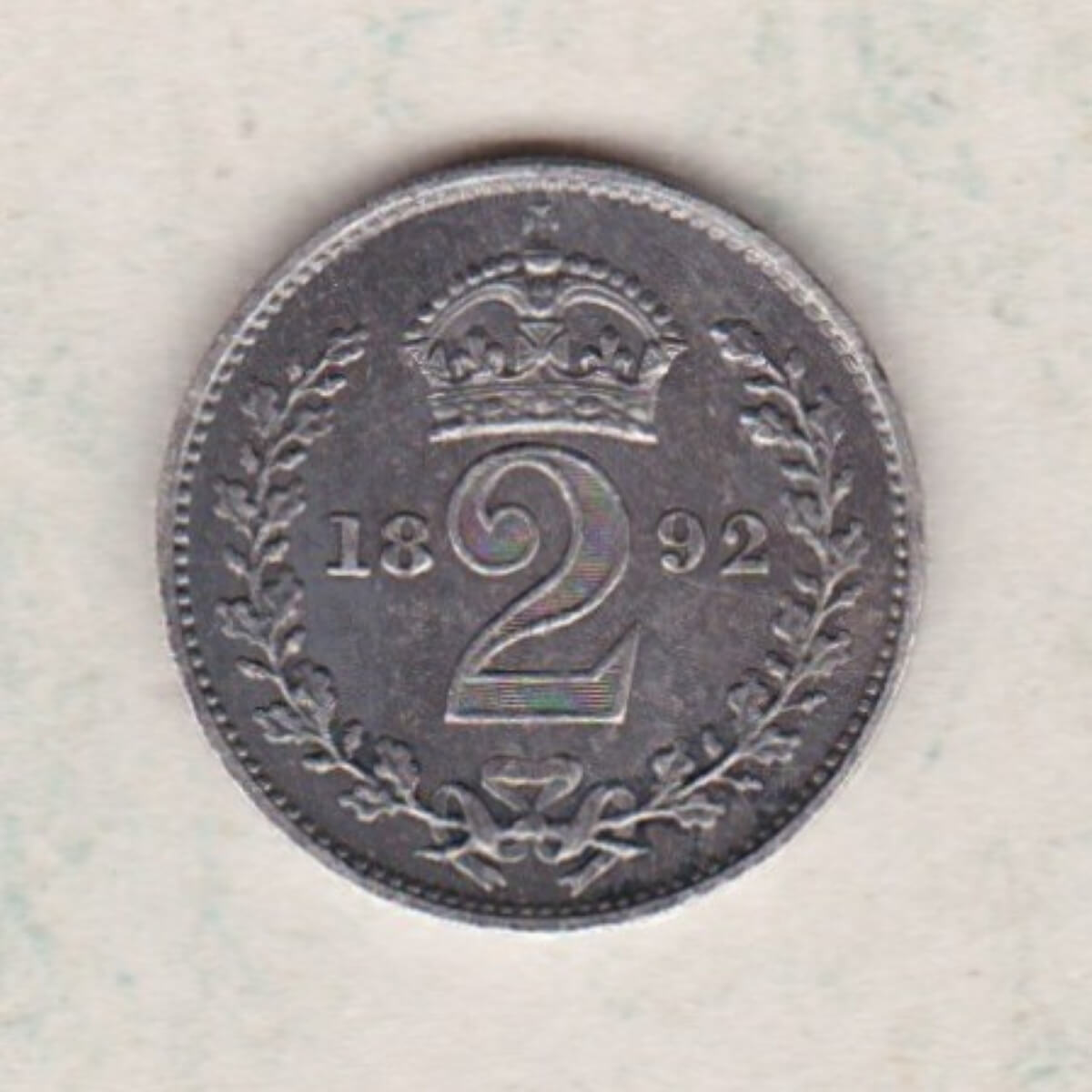 1892 Silver Maundy Twopence coin featuring Queen Victoria on the obverse. A crowned denomination dividing the date on the reverse.