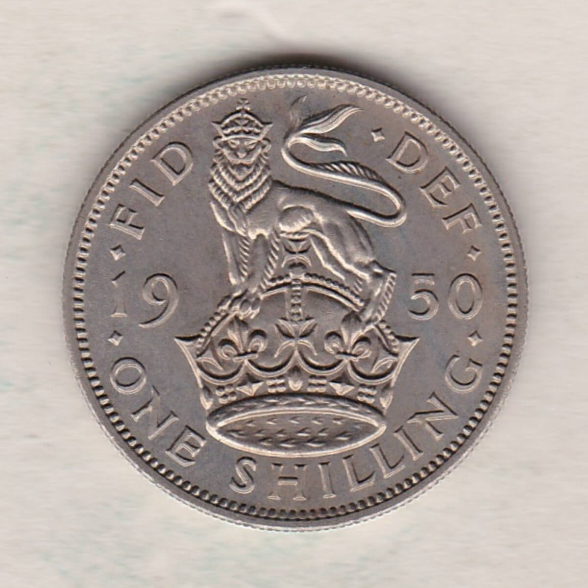1950 proof English shilling cupro nickel coin featuring King George VI on the Obverse. The crowned English lion appears on the Reverse.
