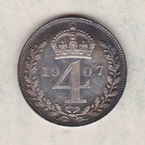 1907 silver maundy fourpence coin featuring king Edward VII on the Obverse. The crowned denomination dividing date within an oak wreath on the Reverse.
