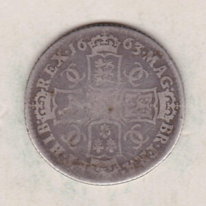 1663 silver shilling coin featuring the laureate or draped bust of King Charles II on the Obverse. The crowned cruciform shields on the Reverse.