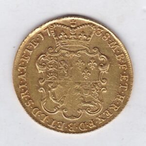 1738 Gold Guinea Coin featuring the portrait of the king George II. The reverse features a crowned quartered shield of arms.