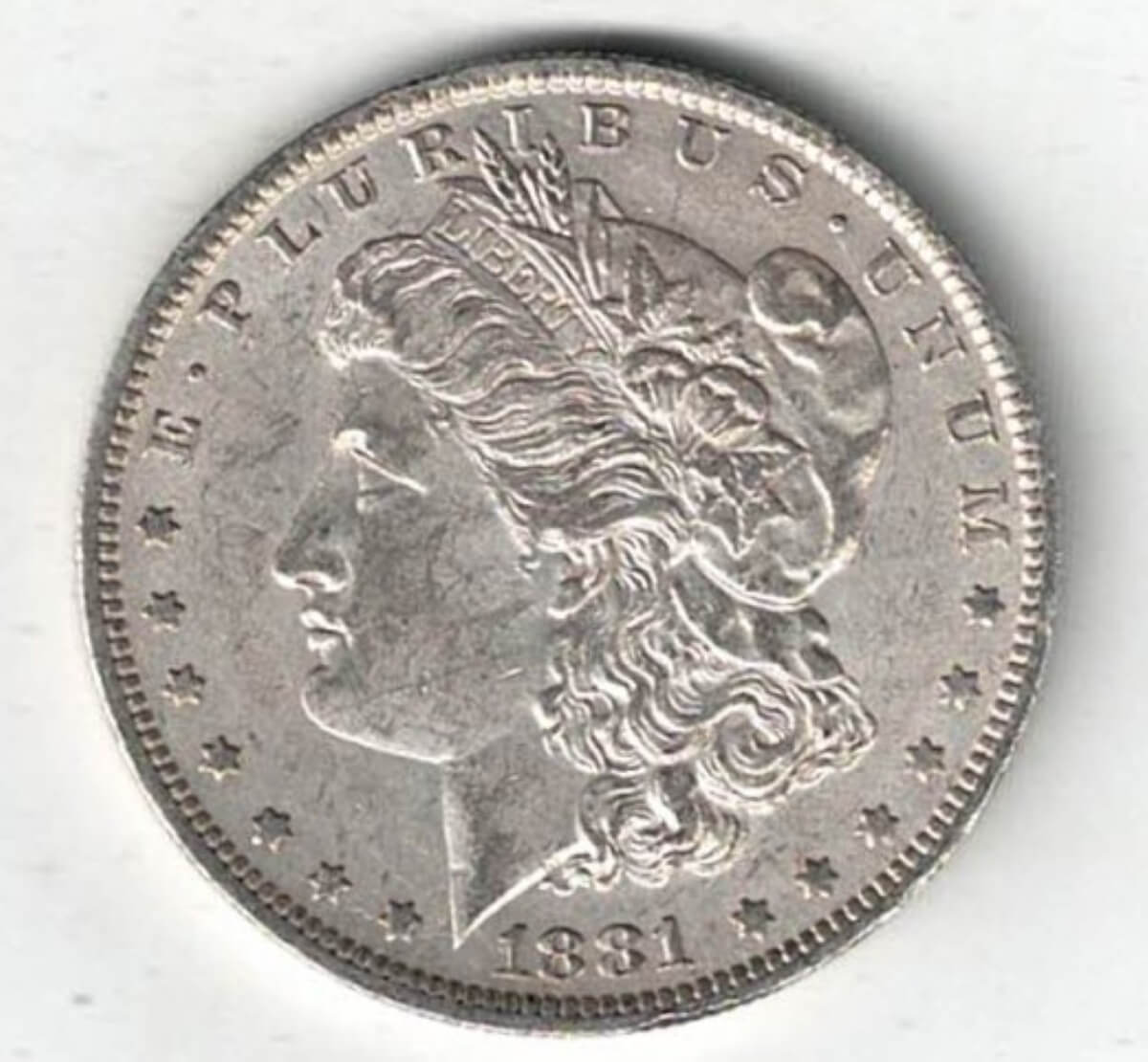 1881 O Silver USA Morgan Dollar coin featuring lady liberty on the obverse. The eagle holding arrows and an olive branch on the reverse.