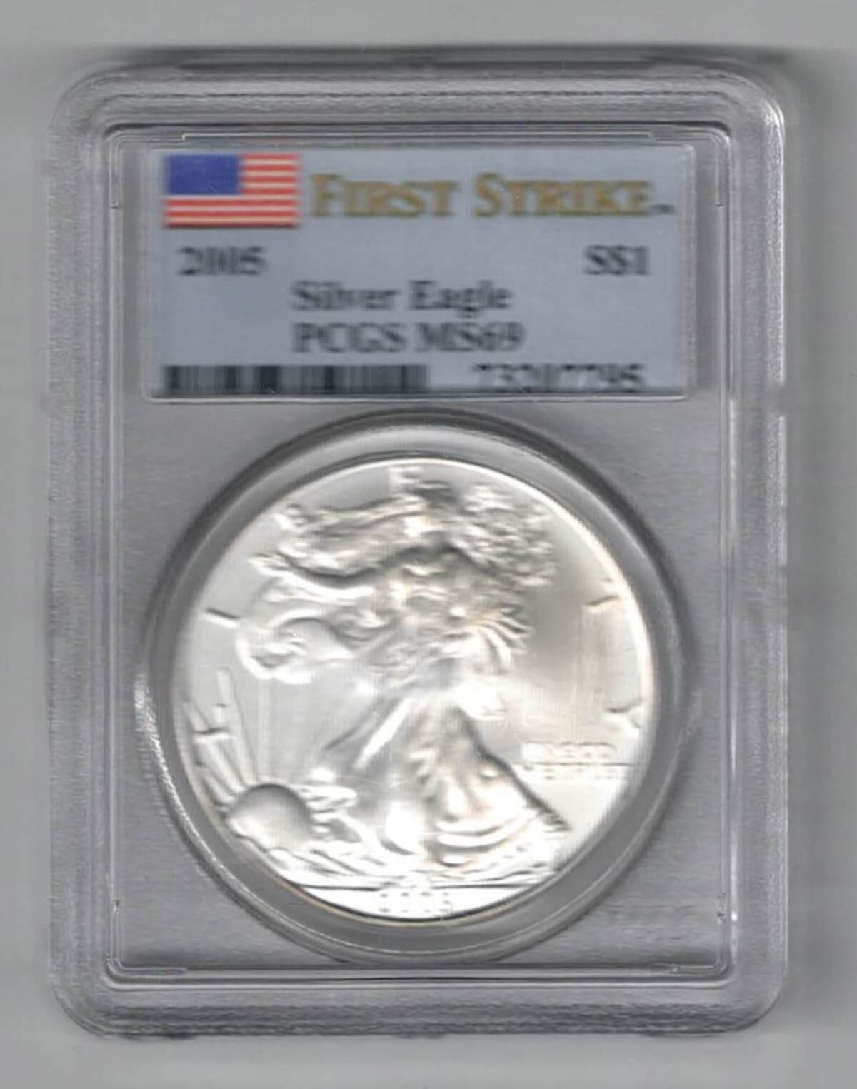 Slabbed PCGS 2005 Silver USA One Ounce Eagle. The liberty is on the obverse, The eagle is on the reverse. The coin contains one ounce of 999 fine silver.