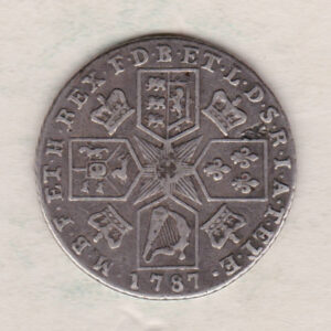 1787 silver shilling coin featuring a laureate and draped bust of George III. The cruciform shields, this coin has no hearts on the Reverse.