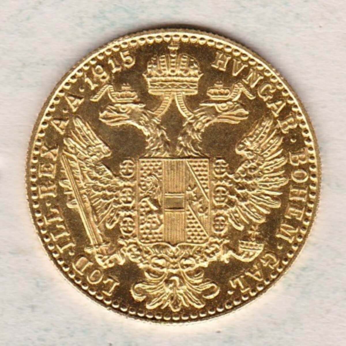 1915 Austria Gold Ducat featuring the portrait of Emperor Franz Joseph I on the Obverse. The double-headed imperial eagle is on the Reverse.